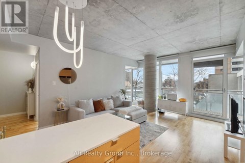 A modern living room with a white couch and a large window.