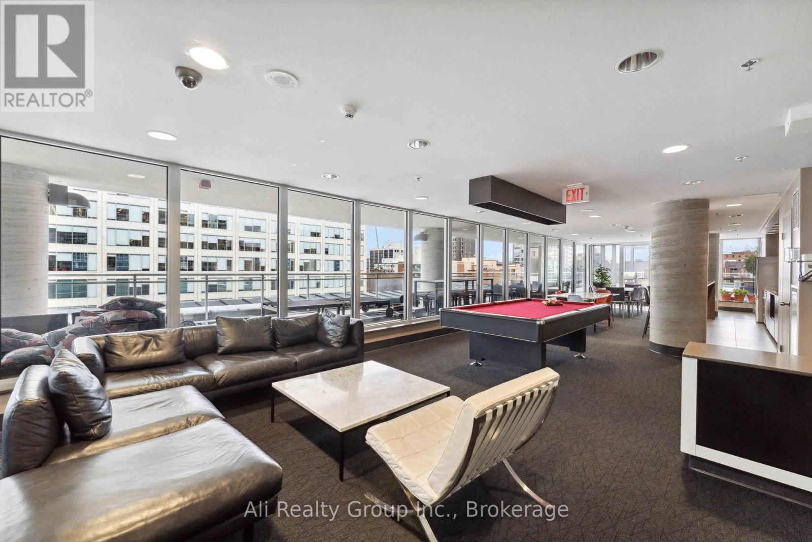 A modern office space with a pool table and comfortable seating.