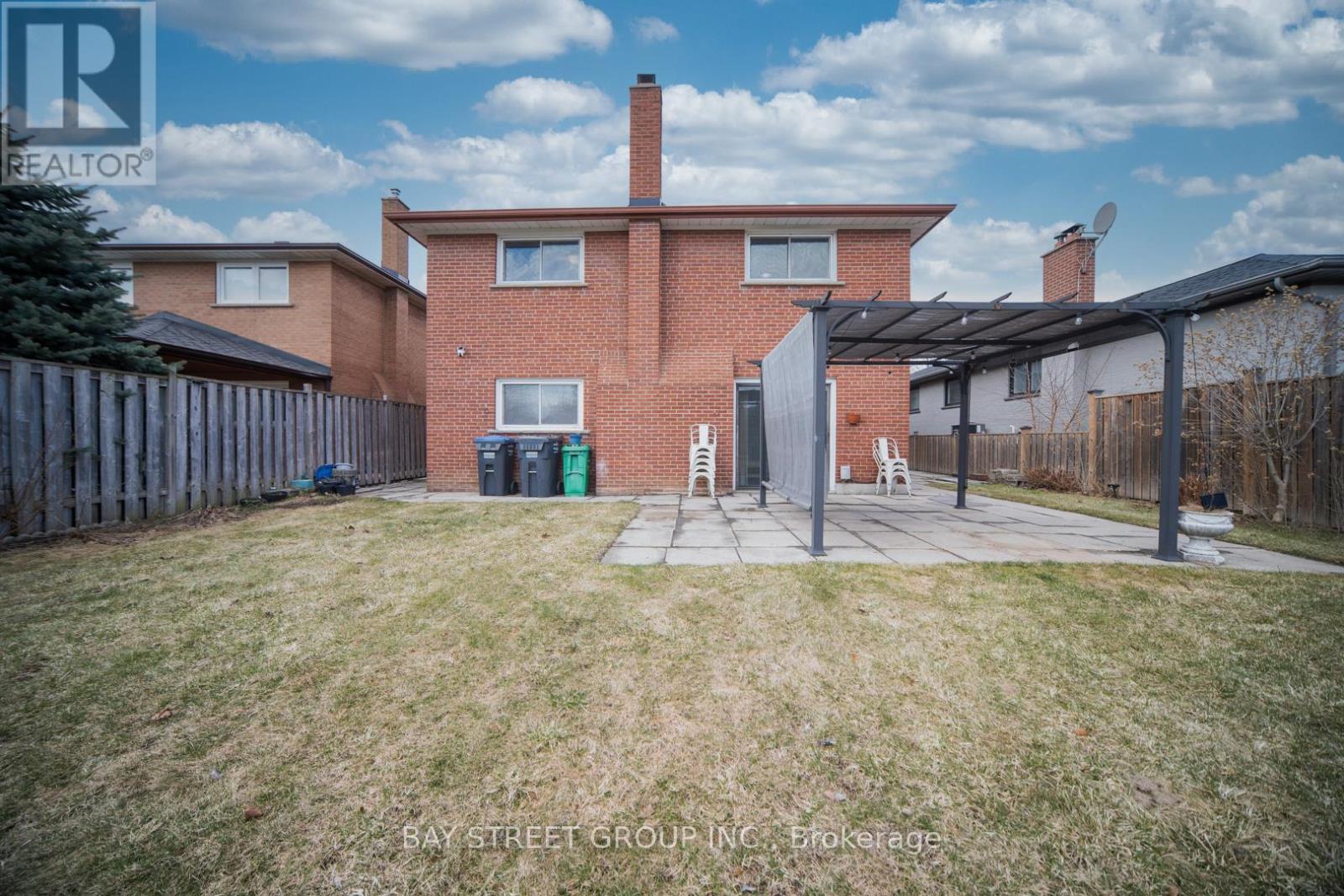 A house with a red brick exterior and a white door is for sale.