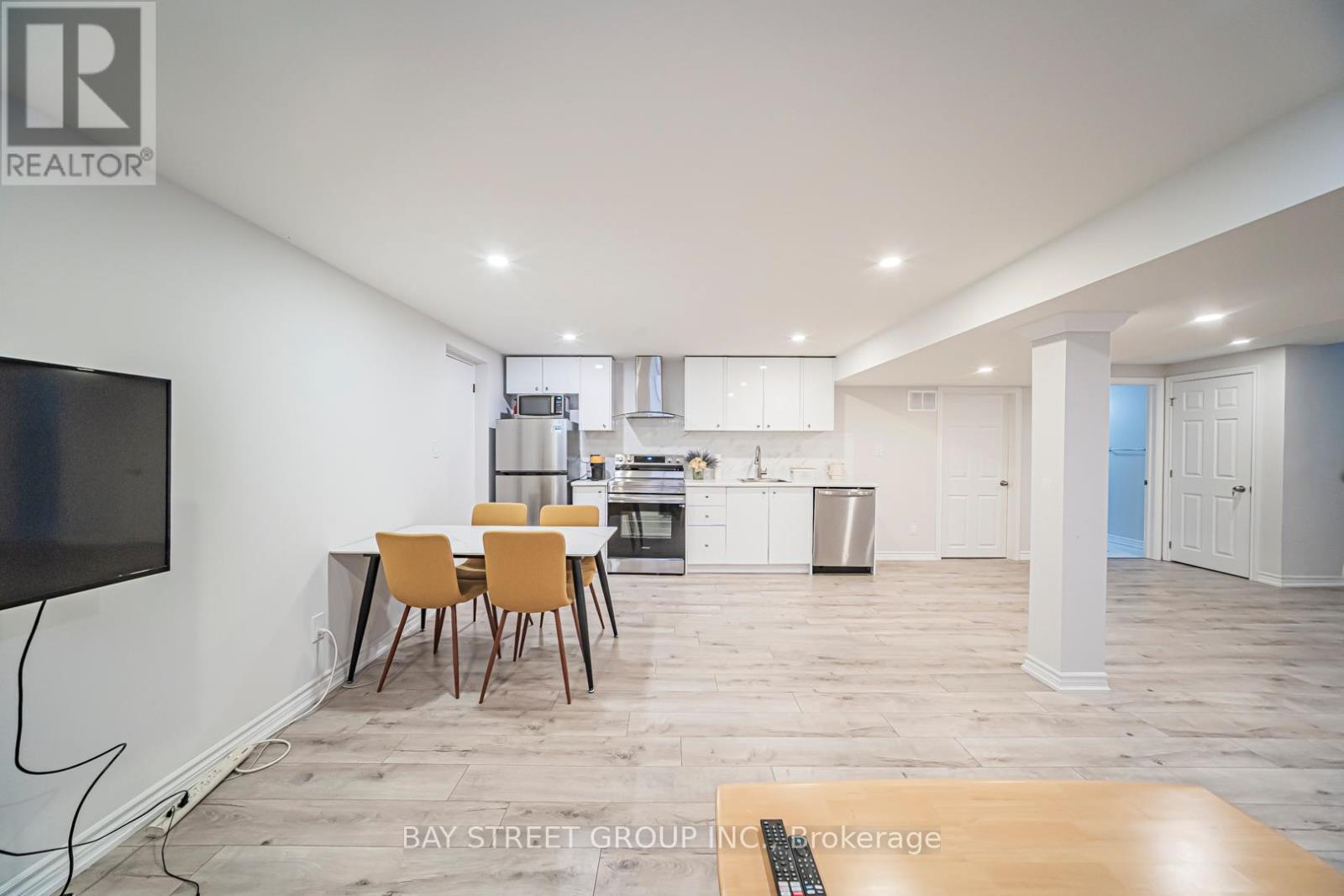 A modern kitchen with a dining table and chairs.