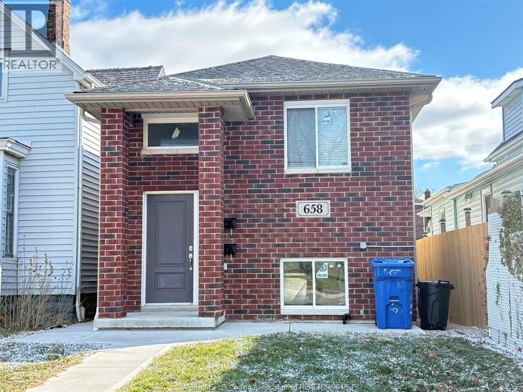 A red brick house with the number 658 on it.