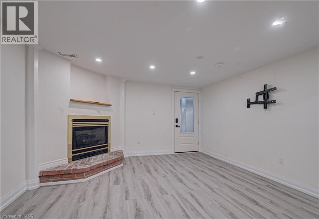 A living room with a fireplace and a door.