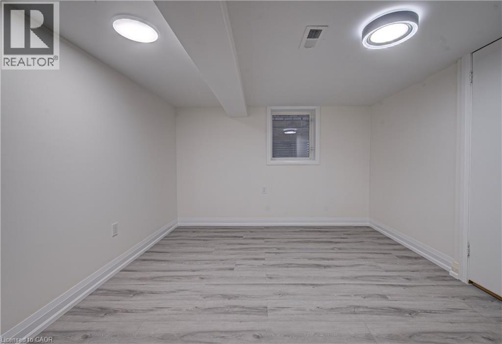 A spacious room with a window and a door on the right side.