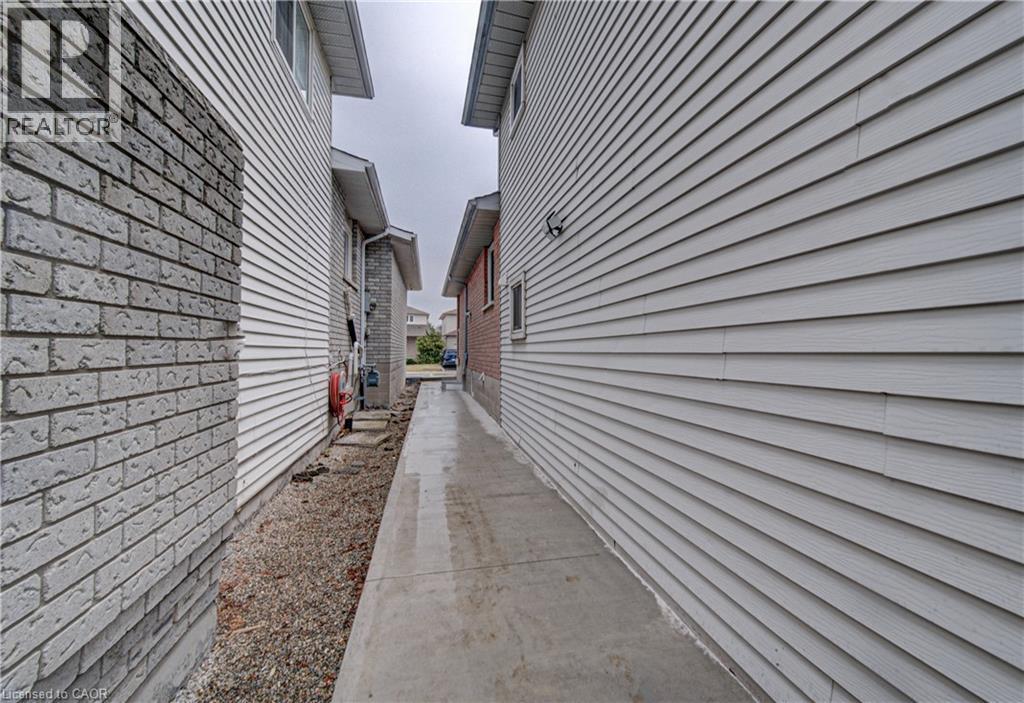 A long, narrow sidewalk runs between two buildings.