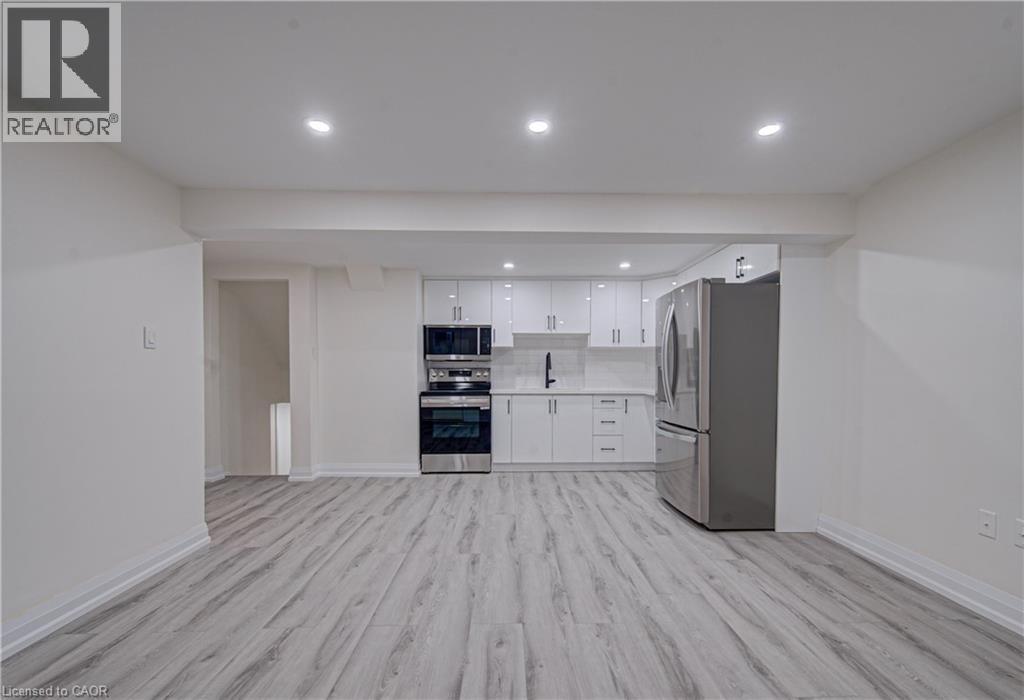 A spacious kitchen with white cabinets and stainless steel appliances.