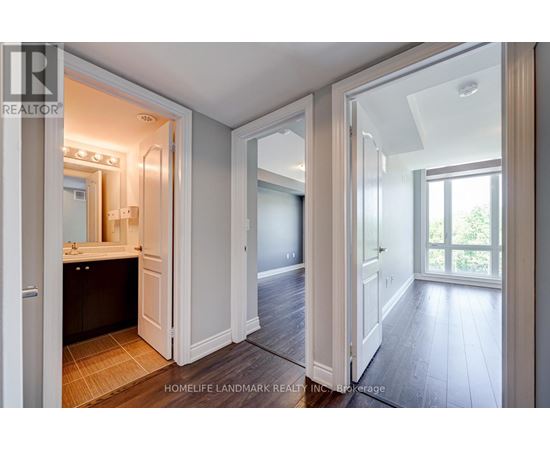 A realtor photo of a home interior with a bathroom, a hallway, and a bedroom.