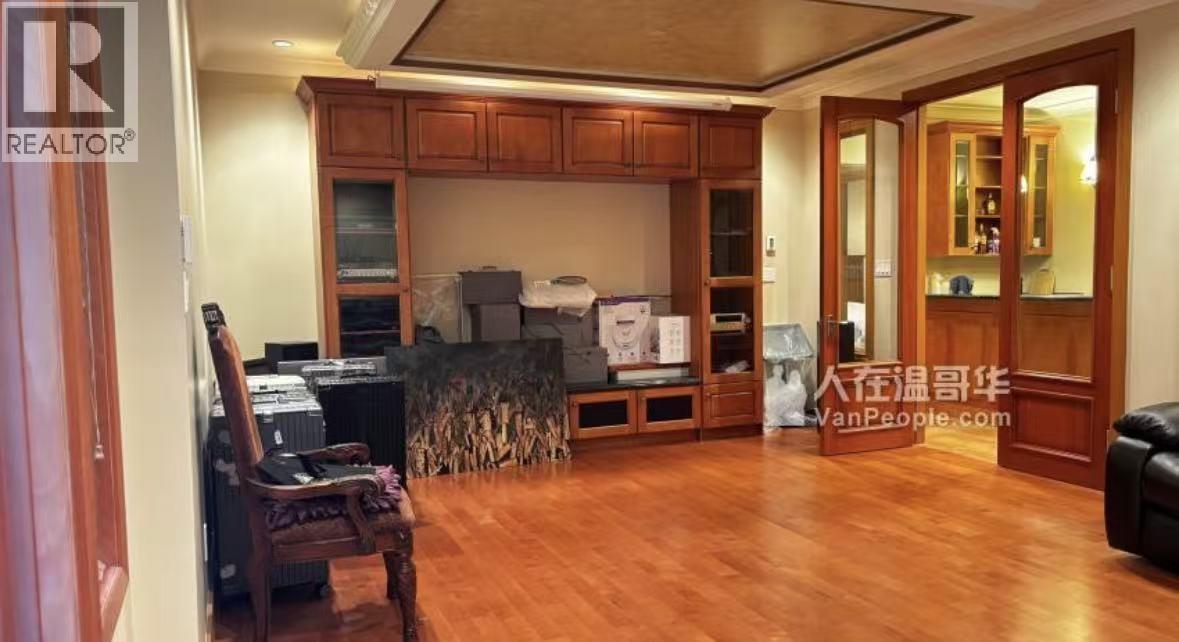 A living room with wooden floors and furniture.