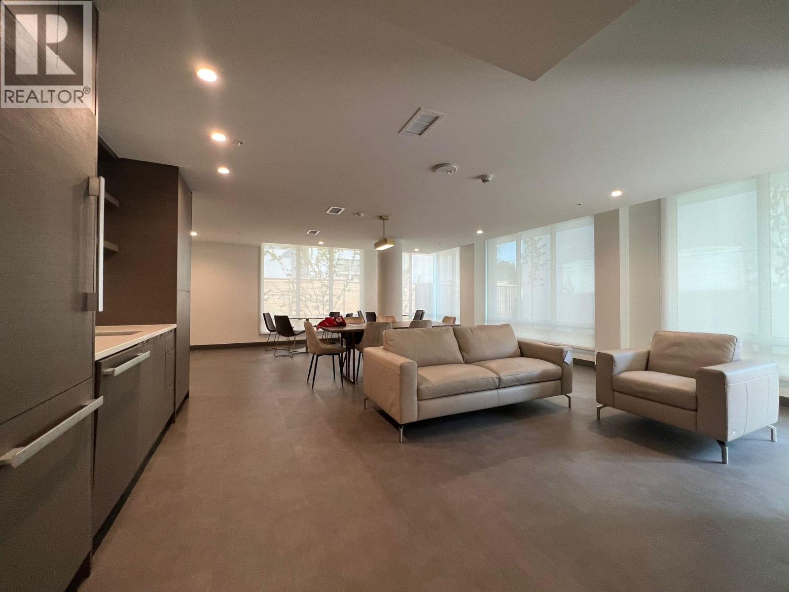 A spacious living room with a dining table and chairs.