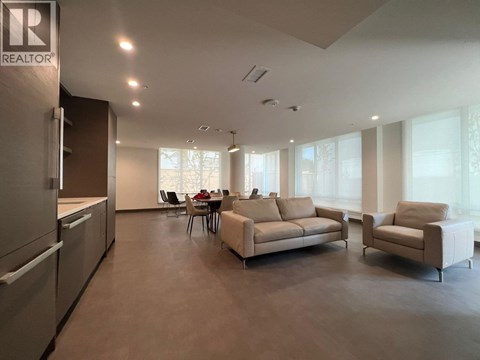 A spacious living room with a dining table and chairs.