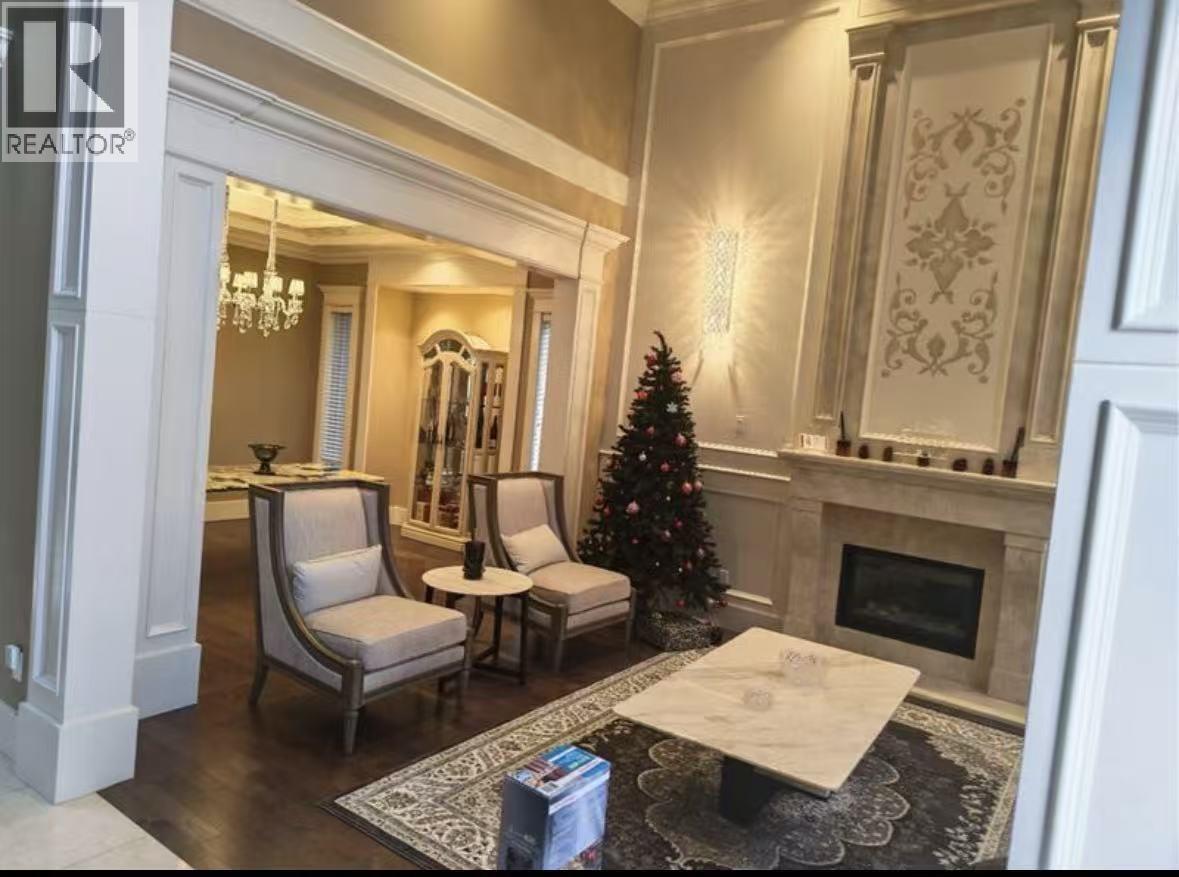 A living room with a Christmas tree and a fireplace.