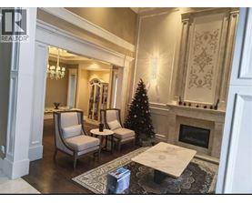 A living room with a Christmas tree and a fireplace.