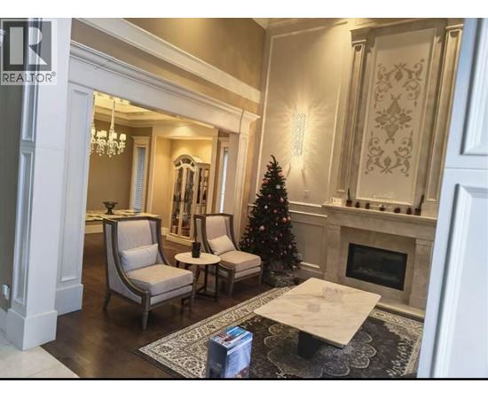 A living room with a Christmas tree and a fireplace.