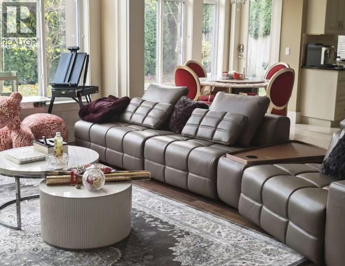 A living room with a grey sofa and a round coffee table.