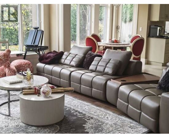 A living room with a grey sofa and a round coffee table.