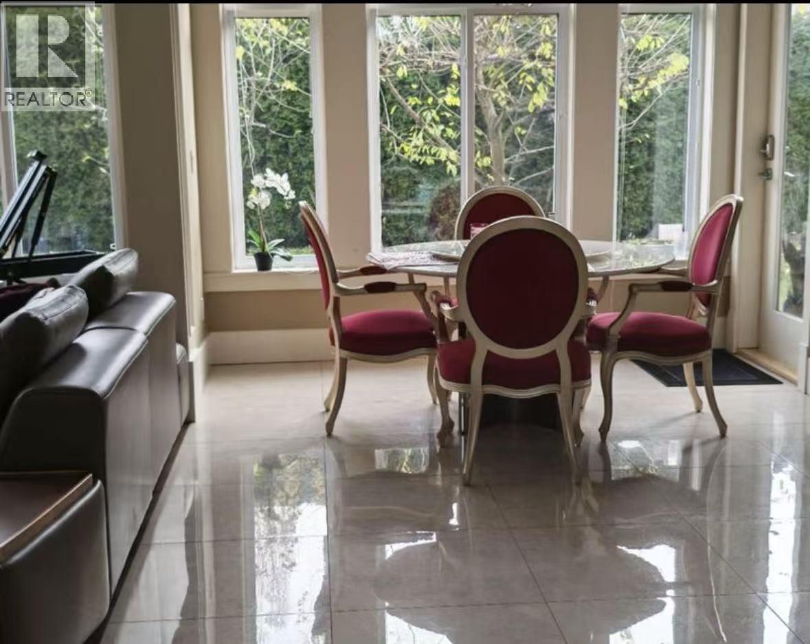 A dining room with a table and chairs.