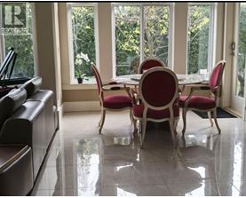 A dining room with a table and chairs.