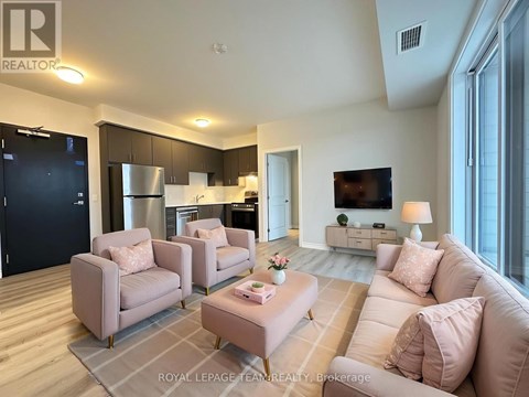 A living room with a grey sofa and a grey armchair.