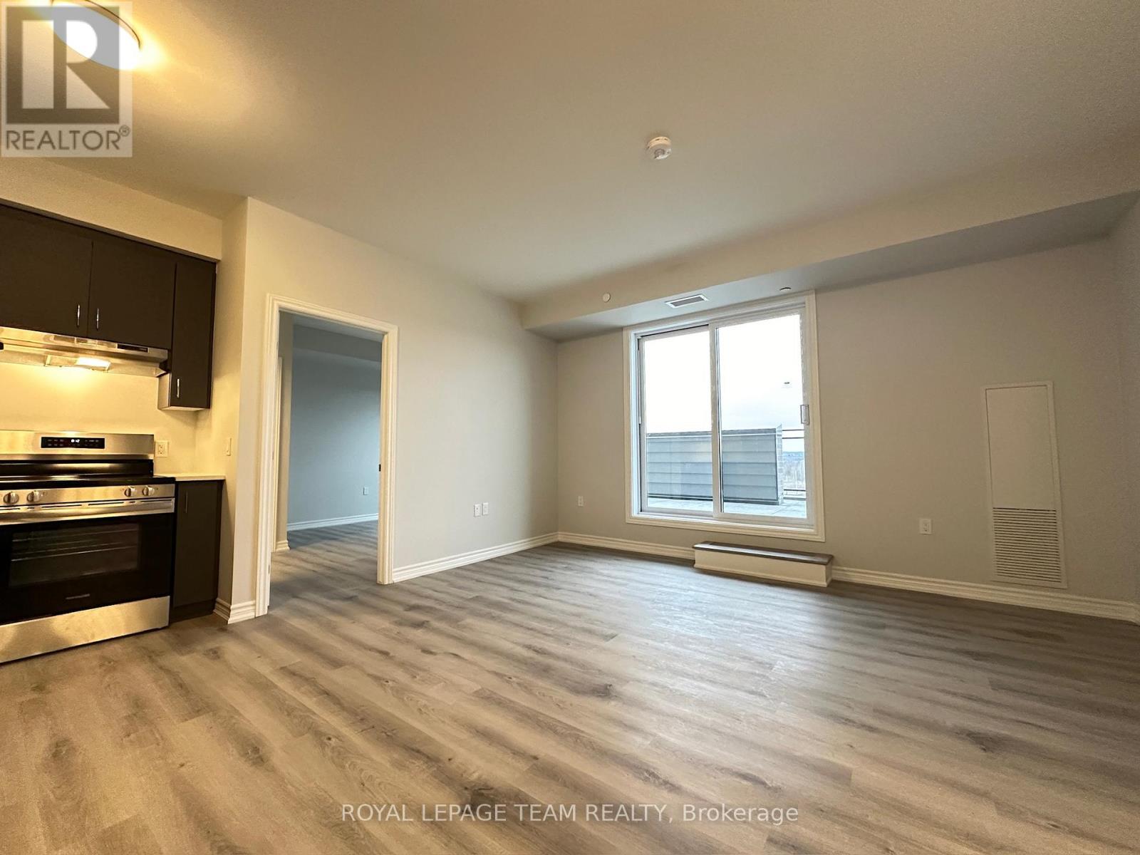 A spacious room with a stove and a window.