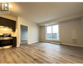 A spacious room with a stove and a window.