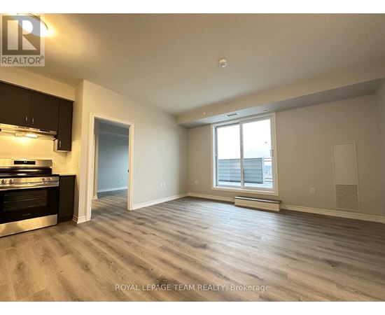 A spacious room with a stove and a window.