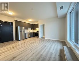 A spacious kitchen with dark wood cabinets and stainless steel appliances.