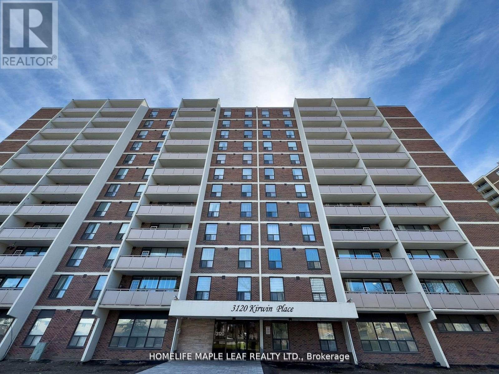 A tall apartment building with the name "Kirwin Place" on the front.