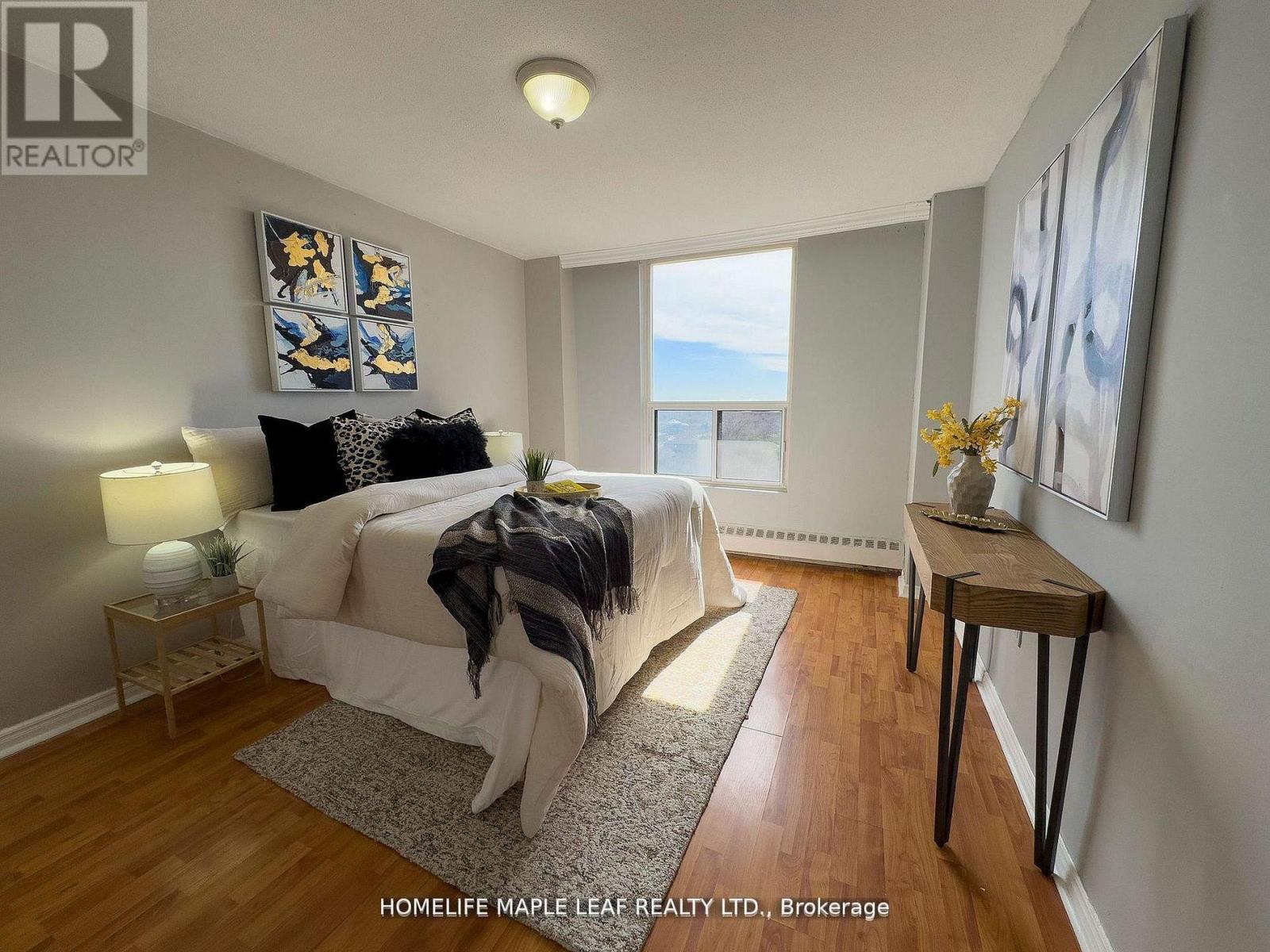 A bedroom with a large bed and a view of the ocean.