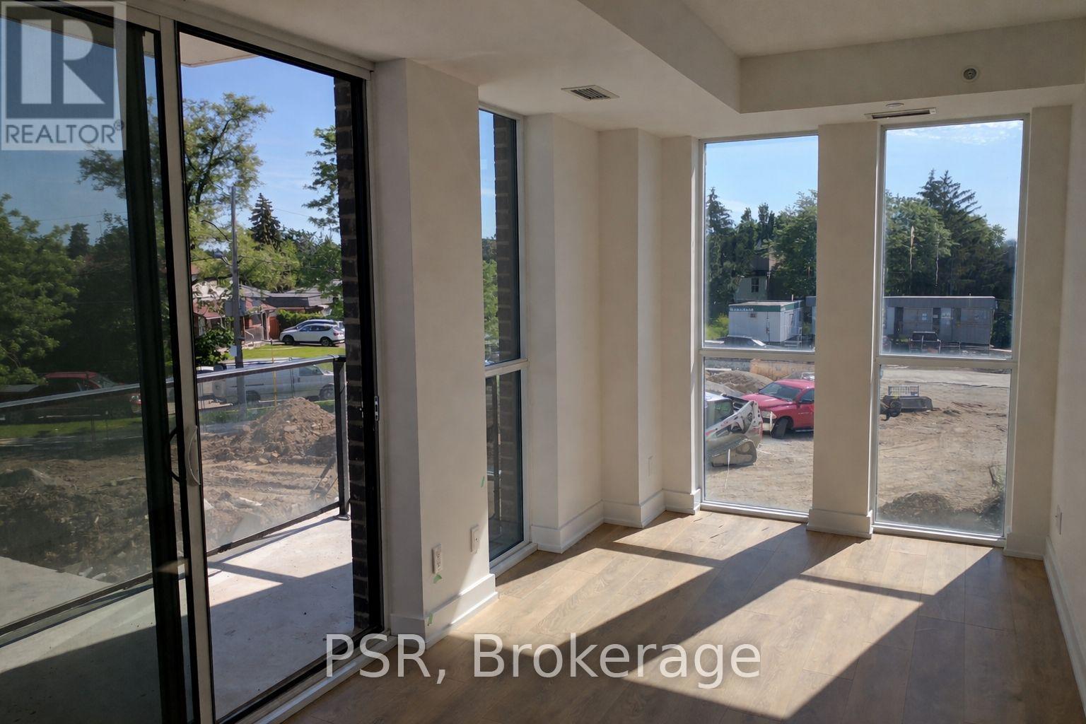 A room with a view of a construction site through the windows.