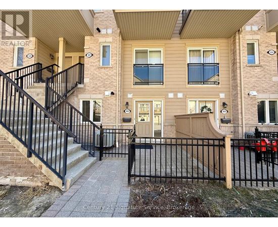 A building with a black gate and a sign that says Century 21.