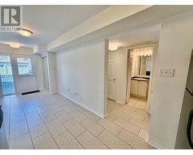 A spacious room with a kitchen area in the back.