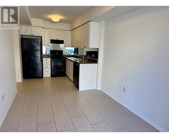 A kitchen with white cabinets and black appliances.