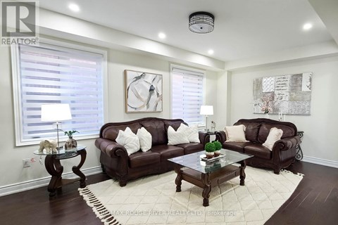 A living room with brown leather couches and a glass coffee table.