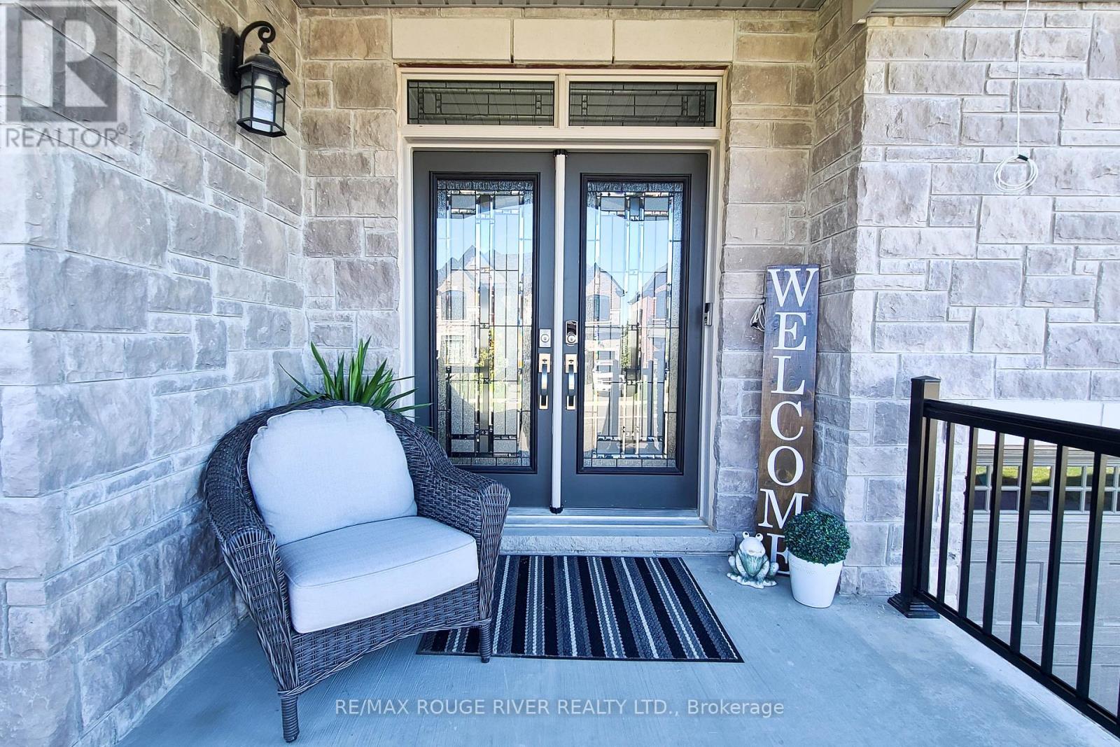 A welcoming entrance to a building with a chair and a sign.