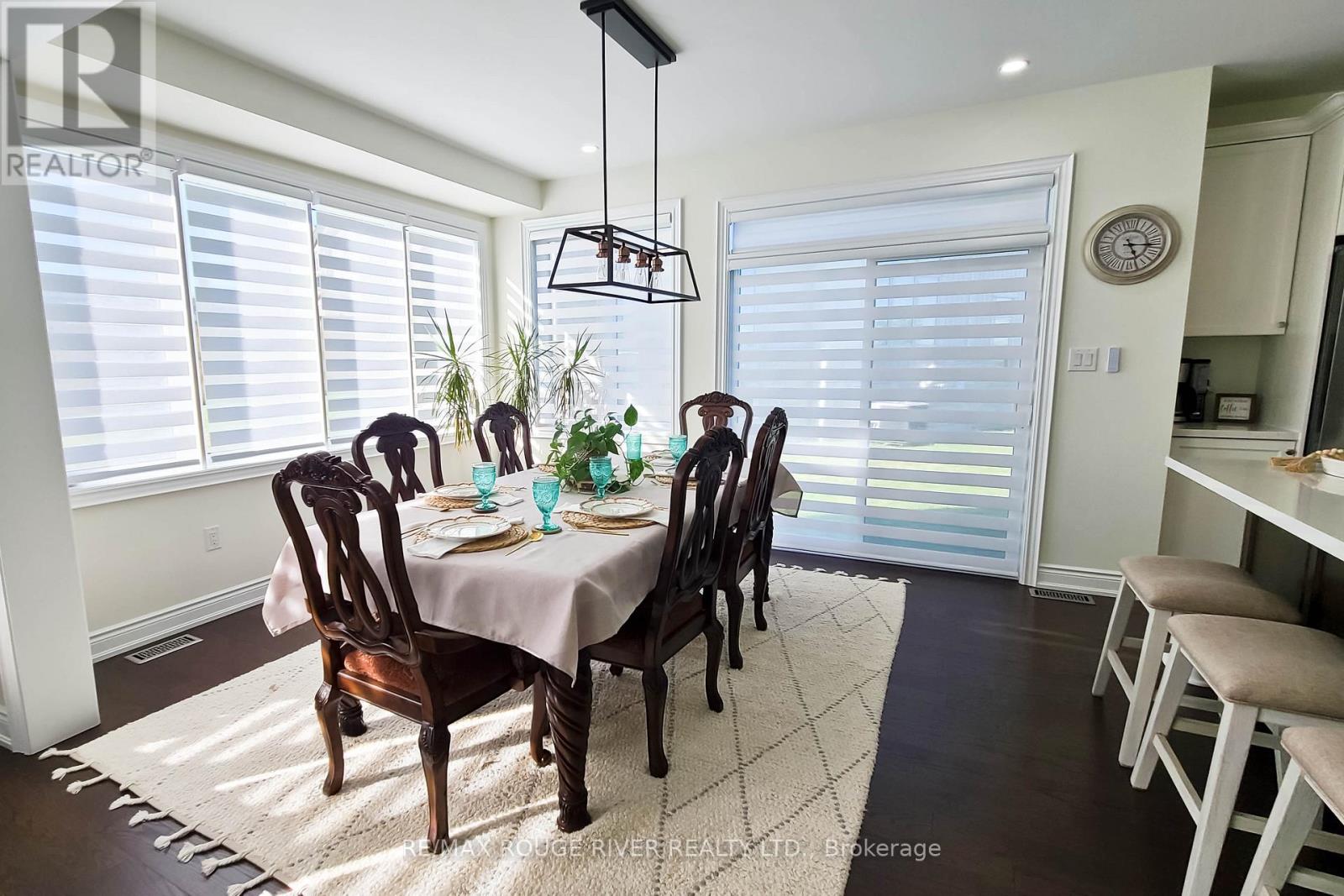 A dining room with a table set for four.