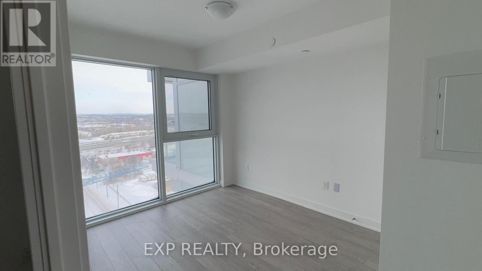 A room with a large window overlooking a snowy landscape.