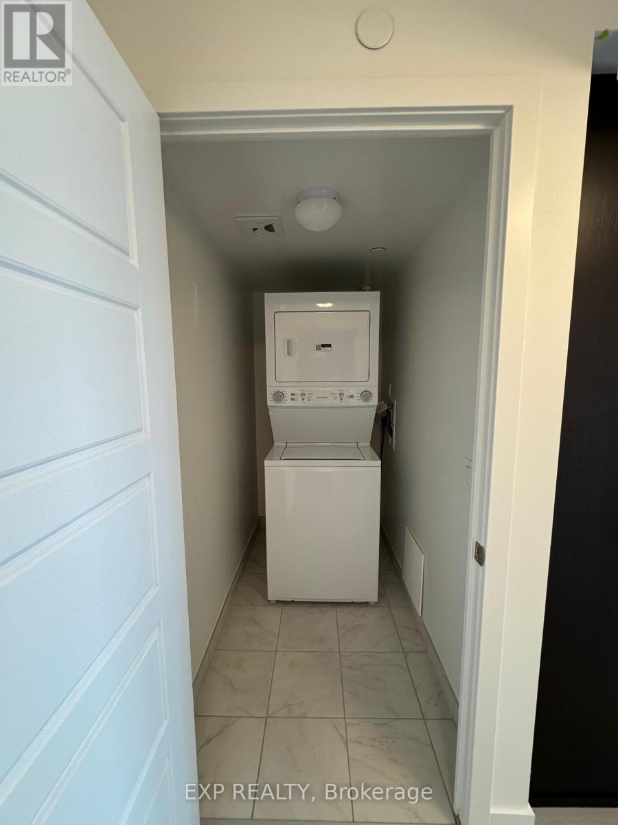 A white washing machine in a narrow hallway.