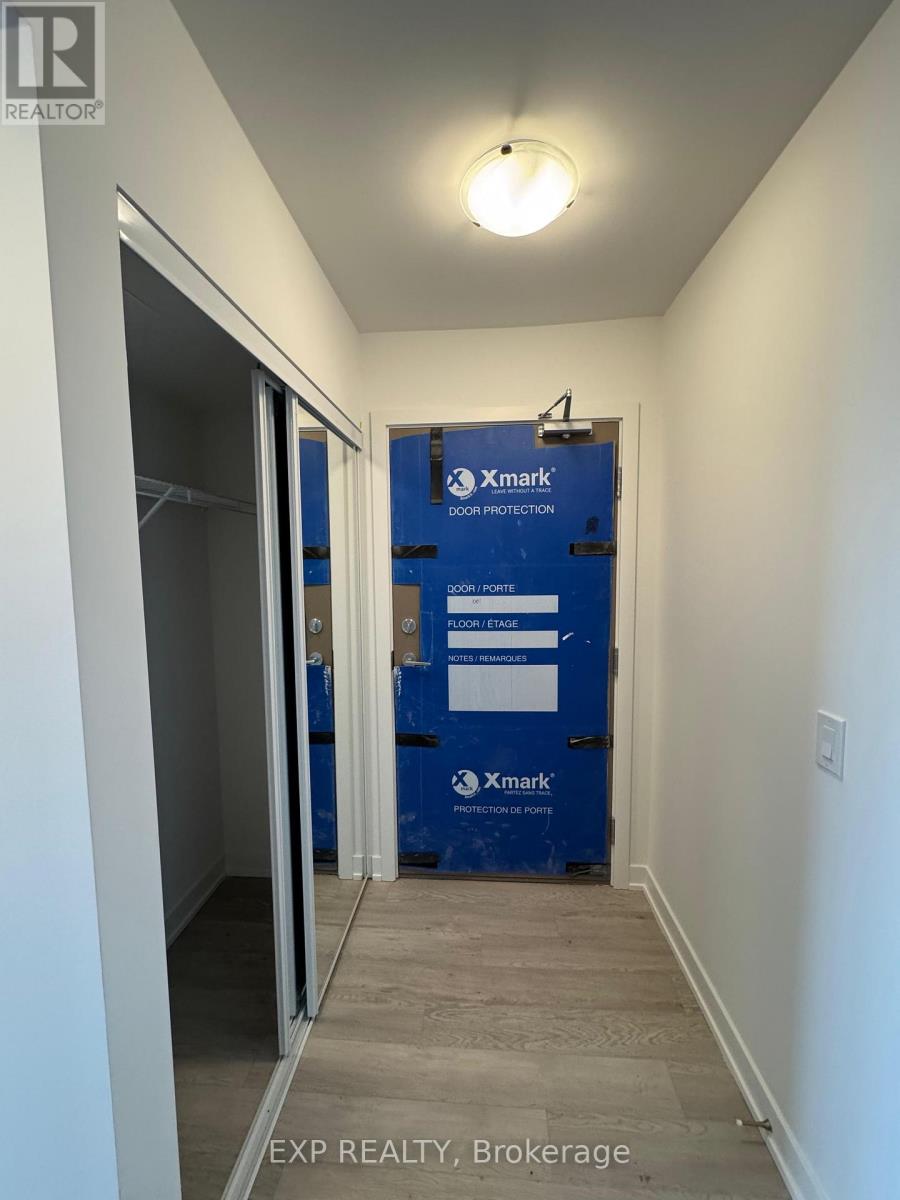 A hallway with a blue Xmark door protection sign on the door.