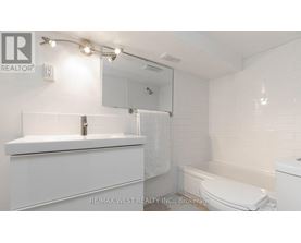 A white bathroom with a sink, toilet, and bathtub.