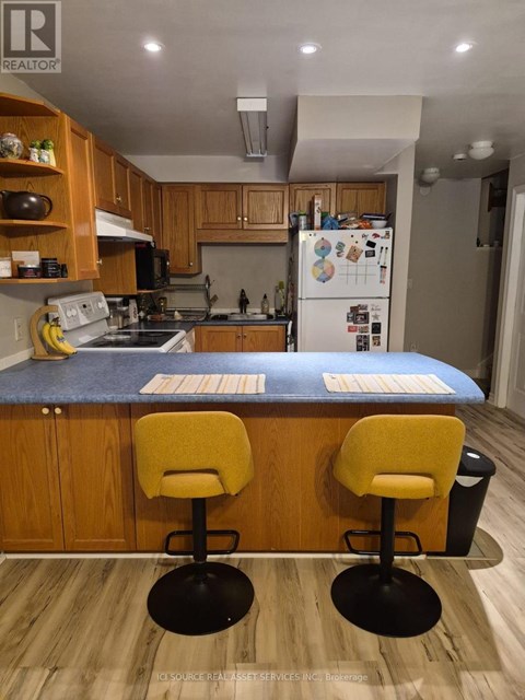 A kitchen with wooden cabinets and a blue countertop.