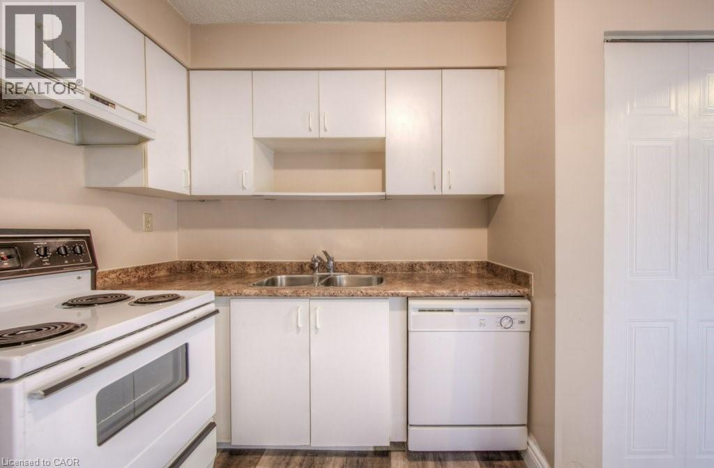 A kitchen with white cabinets and a granite countertop.