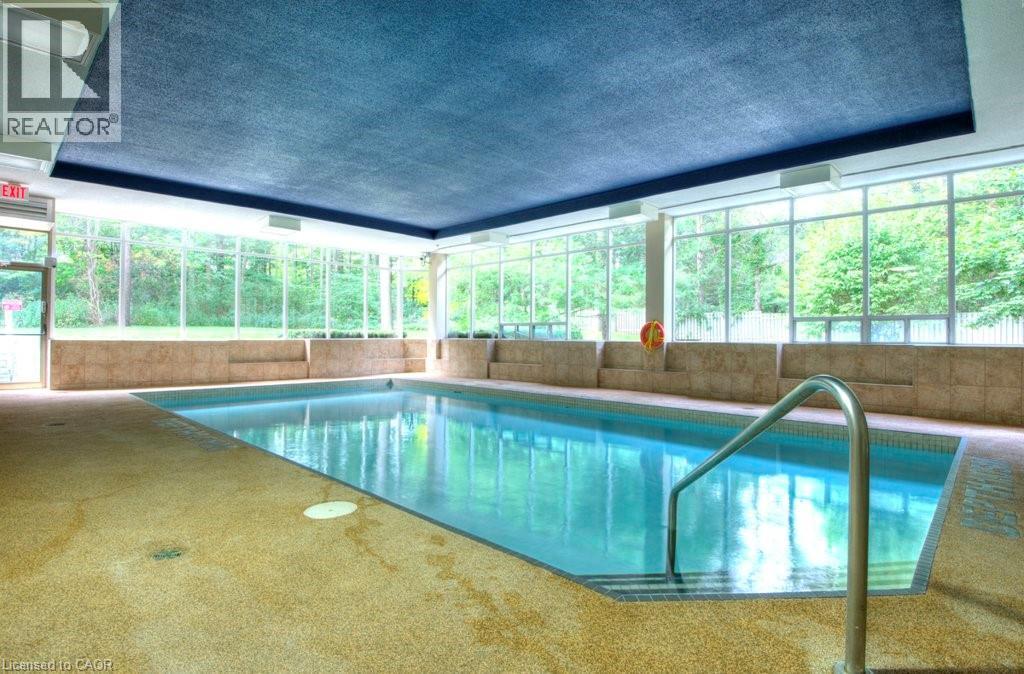 A pool inside a building with a REALTOR sign.