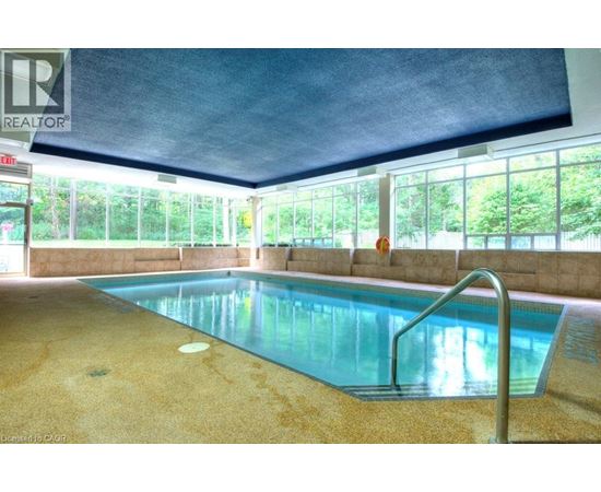 A pool inside a building with a REALTOR sign.
