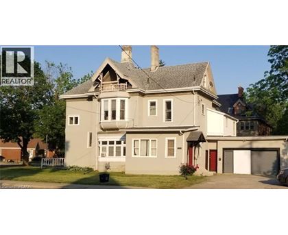 A large house with a grey roof and a red door.