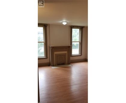 A room with a fireplace and wooden floors.