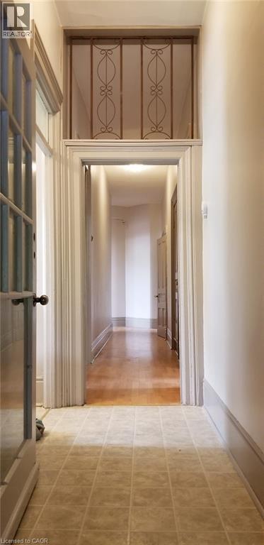 A long hallway with a doorway at the end.