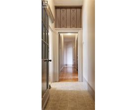 A long hallway with a doorway at the end.