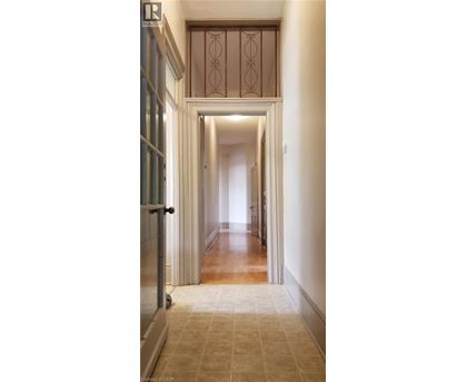 A long hallway with a doorway at the end.