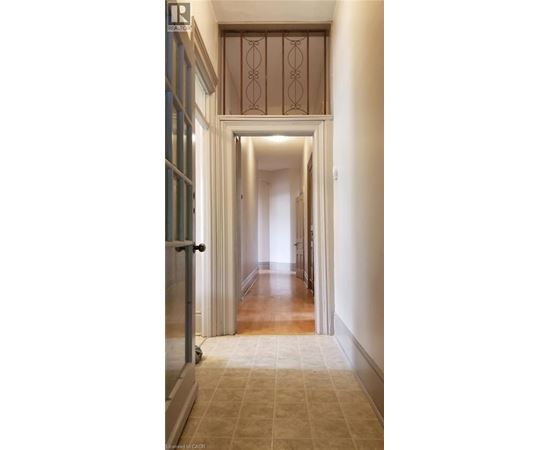 A long hallway with a doorway at the end.