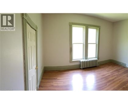 A room with a window and a radiator on the floor.