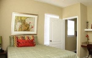 a bedroom with a bed and a desk